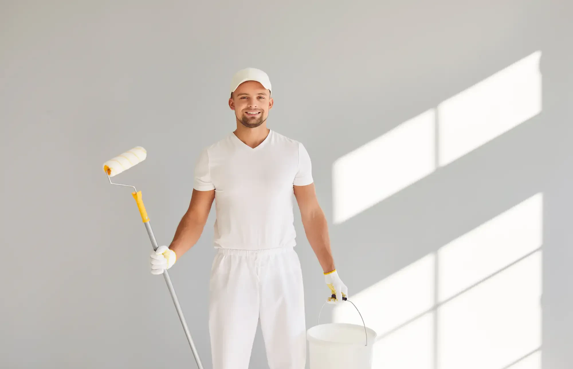 Professional painter roller bucket smiling essex county massachusetts service provided in Essex, Massachusetts with quality workmanship and attention to detail.