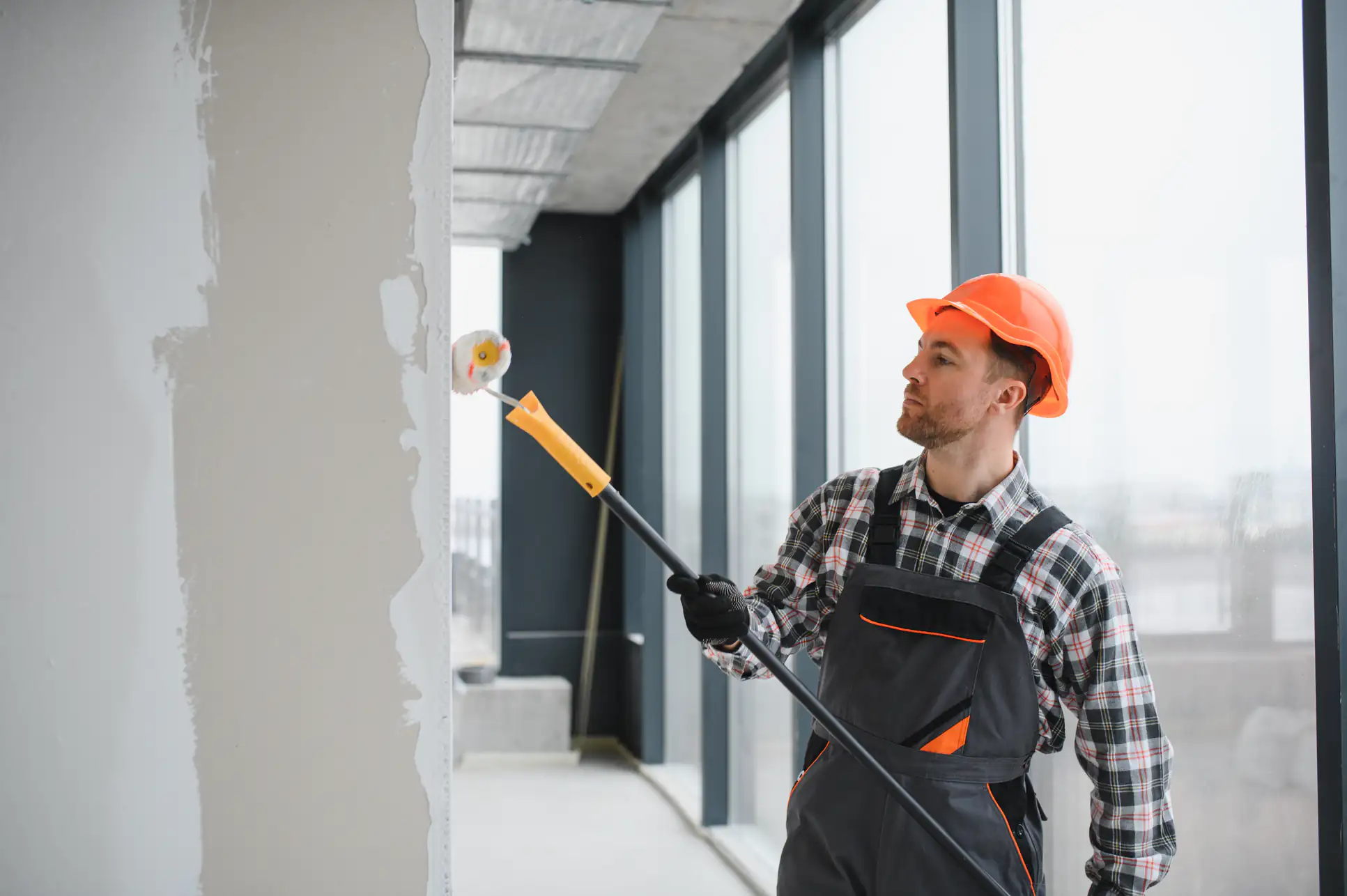 Skilled painter applying fresh coat of paint to interior walls in an Essex County home, enhancing the space with precision and attention to detail for Fine Coat Painters