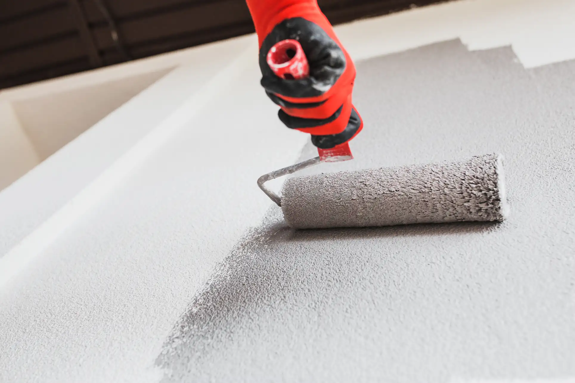 Close-up of a roller painting a smooth wall in Essex County, MA, showcasing Fine Coat Painters’ precision and attention to detail for interior wall finishes.